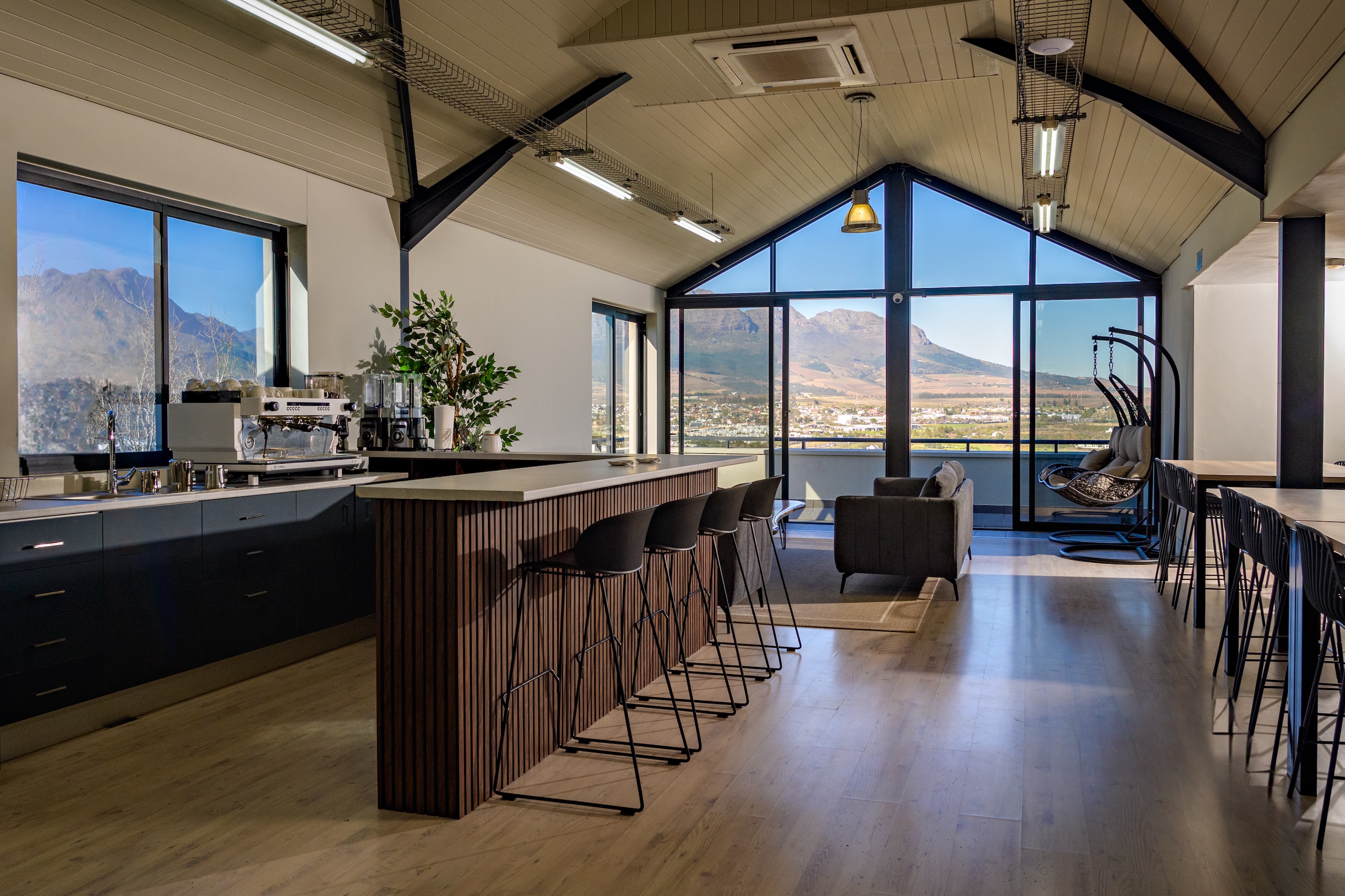CubeSpace's recreation area, with coffee bar, couches, and a view over Stellenbosch, South Africa